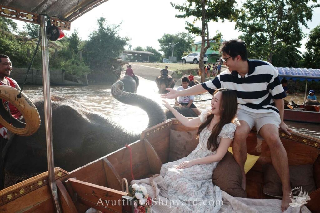 Couple enjoying a private Ayutthaya river cruise, touching an elephant by the riverside, unique cultural experience in Thailand Ayutthaya River Cruise Ayutthaya Private Boat Tour Ayutthaya Island Cruise Elephant & River Life Cruise Ayutthaya Ayutthaya Riverside Photography ล่องเรืออยุธยา ล่องเรือเจ้าพระยา อยุธยา ล่องเรือส่วนตัว อยุธยา ล่องเรืออยุธยา ถ่ายรูป