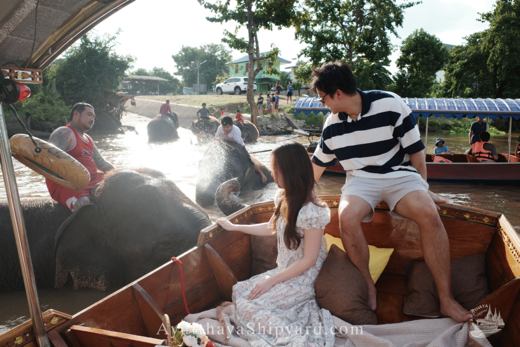 Couple enjoying a private Ayutthaya river cruise, touching an elephant by the riverside, unique cultural experience in Thailand Ayutthaya River Cruise Ayutthaya Private Boat Tour Ayutthaya Island Cruise Elephant & River Life Cruise Ayutthaya Ayutthaya Riverside Photography ล่องเรืออยุธยา ล่องเรือเจ้าพระยา อยุธยา ล่องเรือส่วนตัว อยุธยา ล่องเรืออยุธยา ถ่ายรูป