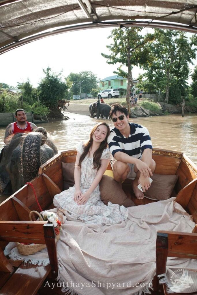Couple enjoying a private Ayutthaya river cruise, touching an elephant by the riverside, unique cultural experience in Thailand Ayutthaya River Cruise Ayutthaya Private Boat Tour Ayutthaya Island Cruise Elephant & River Life Cruise Ayutthaya Ayutthaya Riverside Photography ล่องเรืออยุธยา ล่องเรือเจ้าพระยา อยุธยา ล่องเรือส่วนตัว อยุธยา ล่องเรืออยุธยา ถ่ายรูป